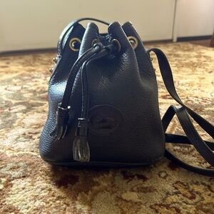 Dooney Bourke small black drawstring bag.